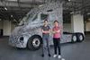 Wen Han, founder and CEO of Windrose Technologies, right, shows Kristoffer Harvey, CEO of Goodman China, one of the Windrose electric trucks