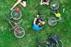 People-with-bikes-on-grass-shutterstock-789645064-scaled