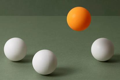 orange-ball-floating-above-white-balls-hero